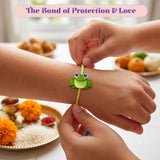 A bright green frog-shaped charm with large round eyes on a yellow braided string cartoon animal rakhi bracelet