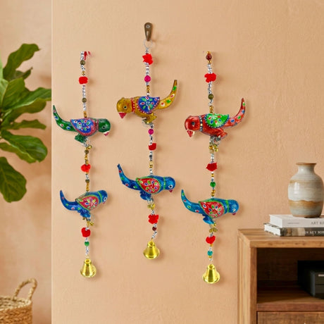 Vibrant Rajasthani parrot wind chime wall hanging with floral patterns, beads, bells