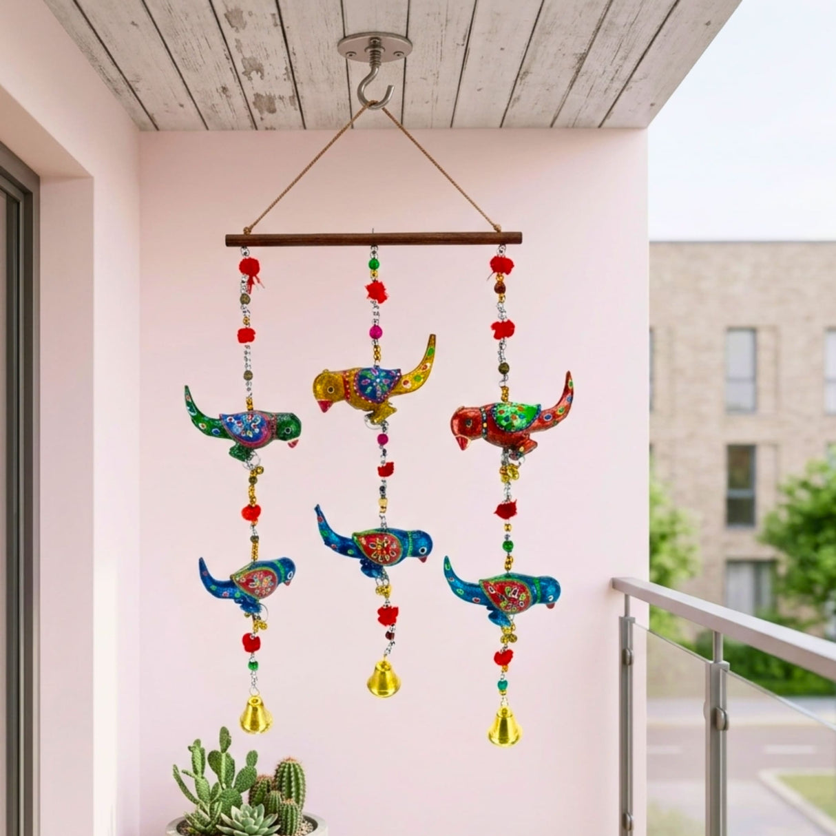 Colorful Rajasthani parrot wind chime with red pom-poms, gold bells, 14 inches
