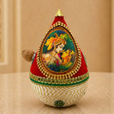 Red and cream embroidered teardrop decorative coconut with gold bead trim green lace and radha-krishna painting for wedding pooja