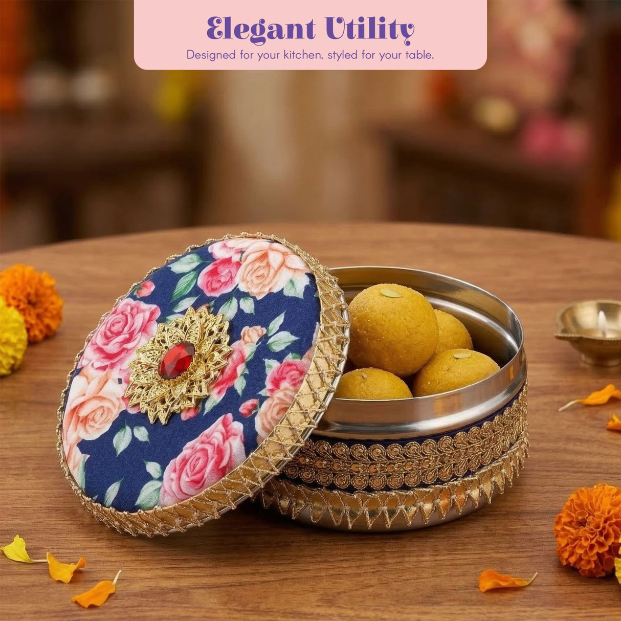 Navy blue floral gotta steel ladoo box with gold lace trim and red gem centerpiece