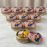 Ornate gotta steel ladoo box with navy blue rose-embroidered lid and red gem, 400g wedding gift