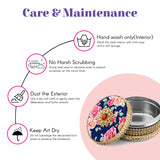Decorative gotta steel ladoo box with navy blue floral lid, pink roses, gold accents
