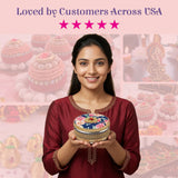 Decorative gotta steel ladoo box with navy floral lid in hands