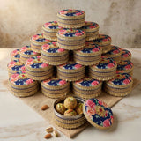 Stacked navy blue floral Gotta Steel Ladoo Box pyramid with pistachio sweets