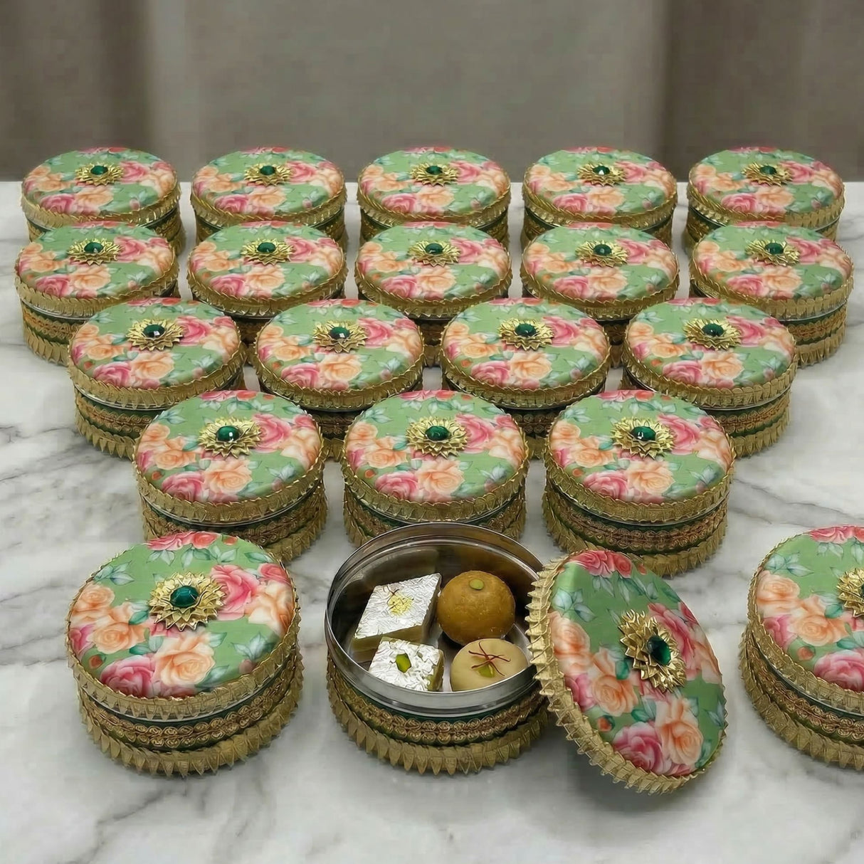 Green Gotta Steel Ladoo Box with floral gold jeweled design and sweets