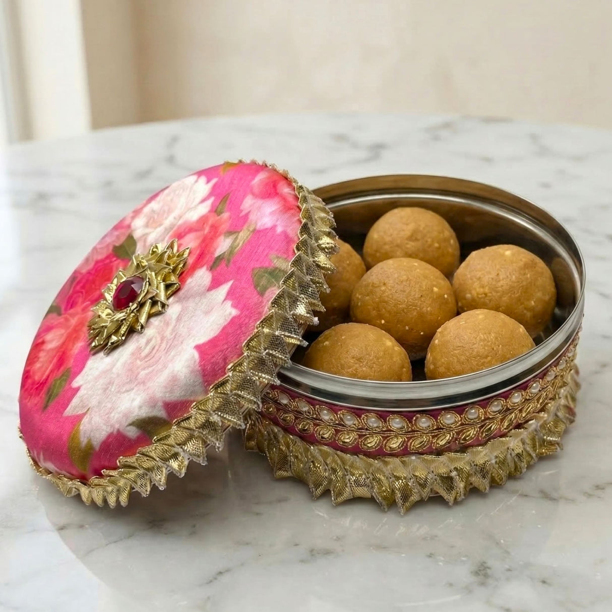 Pink floral gotta steel ladoo box with gold trim, red gem clasp, 400g wedding gift