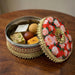 Decorative gotta steel ladoo box with red floral lid holding 400g Indian sweets