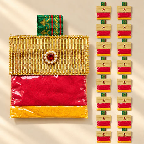 Decorative handbag style mini haldi kumkum packet with gold beads, red gemstone clasp, green handle, and vibrant fabric lining