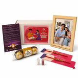 Designer Rakhi Gift Hamper for Brother & Bhabhi – Adjustable Rakhi Bracelet with Photo Frame, Chocolates, Roli Chawal & Card for Raksha Bandhan