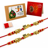Gold-colored elephant and bro charm rakhi with red thread from 2pc designer rakhi bracelet gift set for brother and sister-in-law