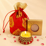Red drawstring brocade potli bag with gold embroidered paisley patterns and matching golden fabric top for diwali gifts