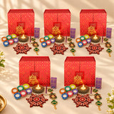 Red patterned boxes featuring festive diwali diyas and decorative items in an indian festival gift hamper