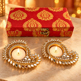 Two ornate gold-plated diya candle holders with intricate mirror and crystal paisley design in diwali gift hamper set