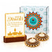 Golden led diwali light box with happy diwali engraving and candle silhouettes on dark wood base in festive gift set