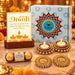 Golden ornate diya holders with intricate floral designs and embedded pearls included in diwali gift hamper set
