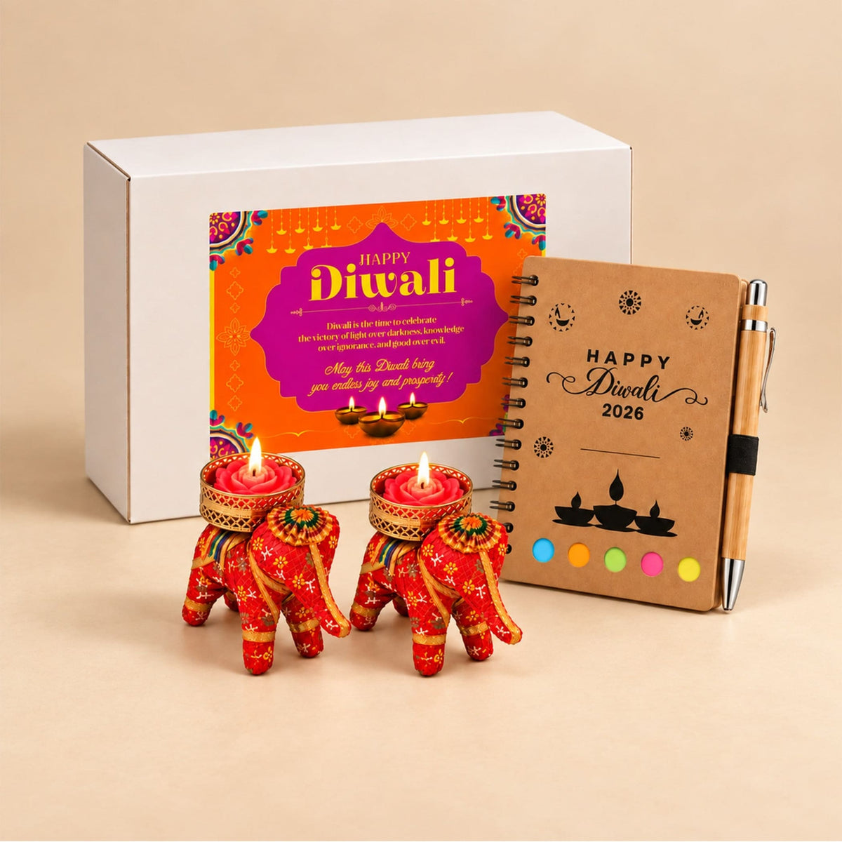 Red elephant-shaped tealight candle holders with intricate gold and green embroidery in Diwali gift hamper
