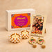 Pearl-encrusted diya tealight candle holder with lit candle in Diwali gift hamper for family and friends