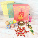 Decorative boxes and festive Diwali items in a gift hamper for celebrations