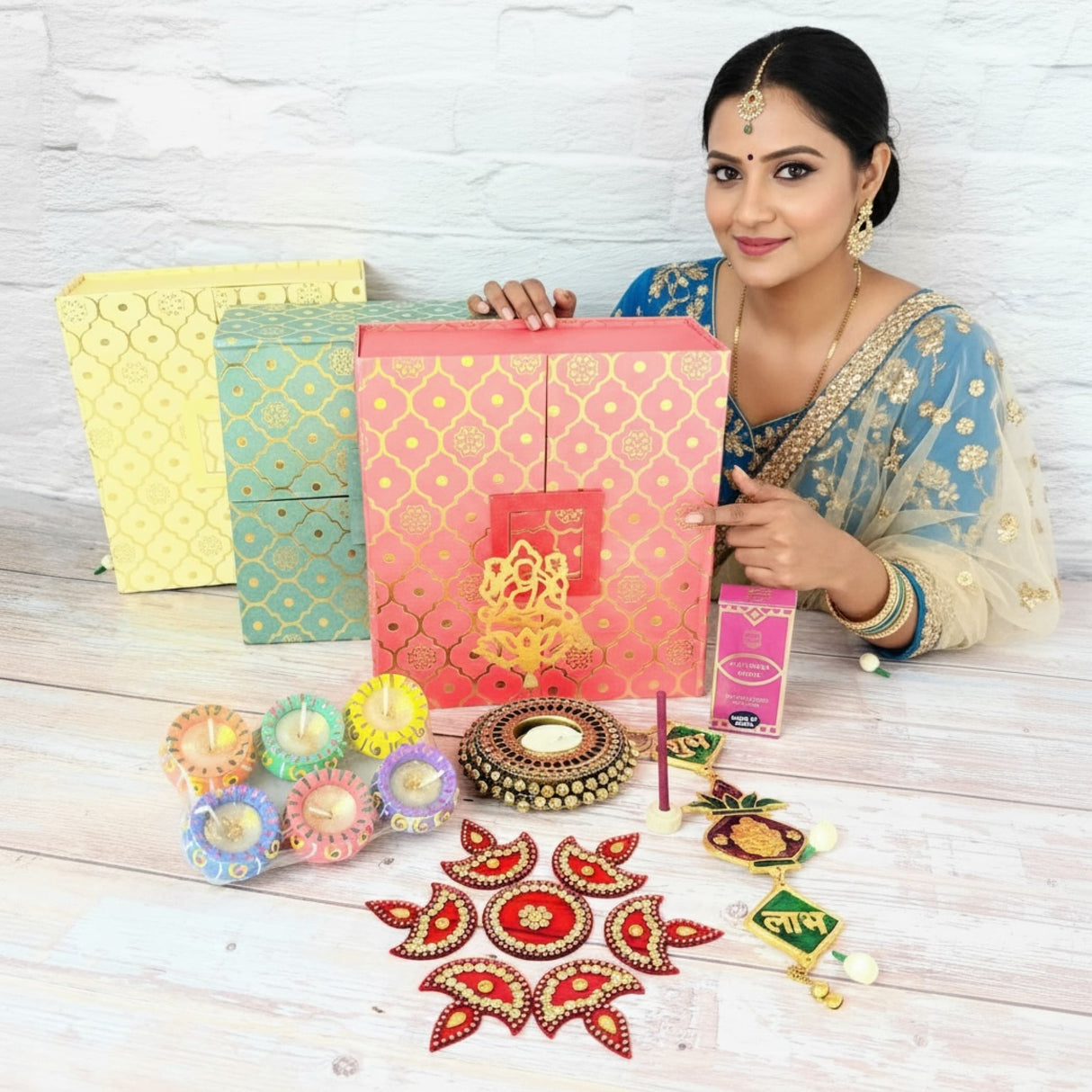 Indian woman in traditional attire with festive gift boxes and decorative Diwali items