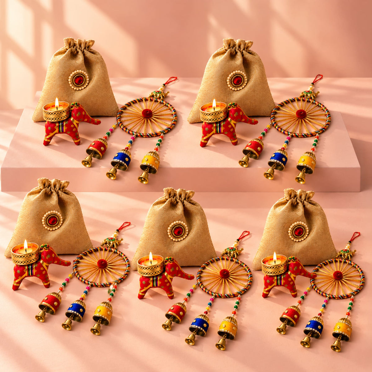 Beige jute drawstring bags with red and gold decorative elephant candle holders for Diwali and festive gift hampers