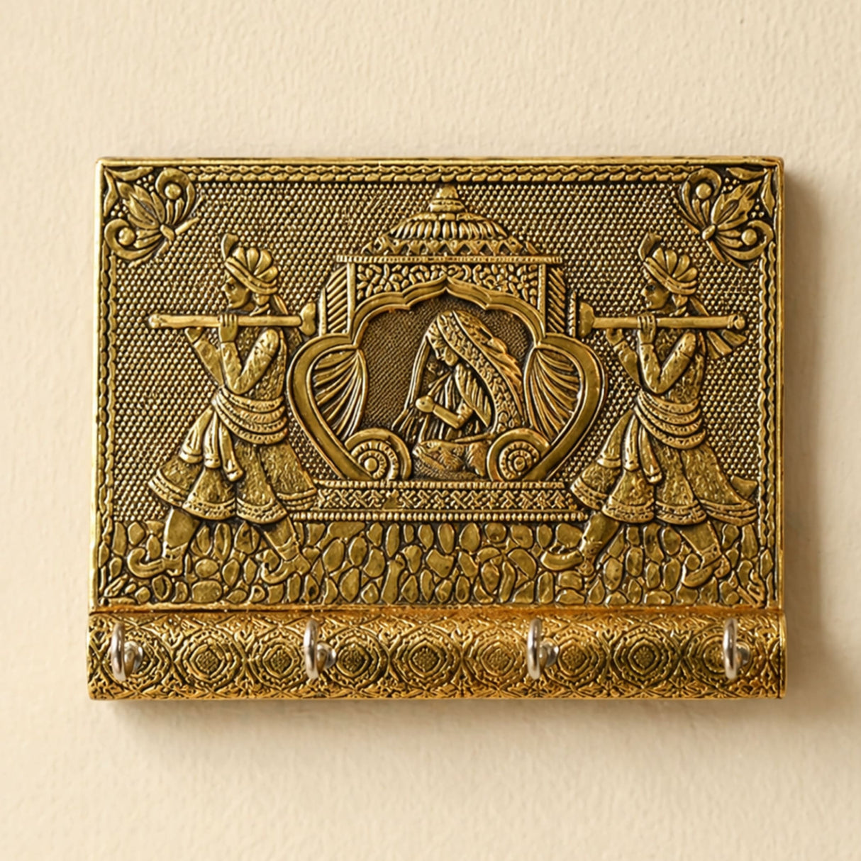 Golden brass decorative indian doli wall-mounted key holder with intricate engraved musicians and four hooks for home use