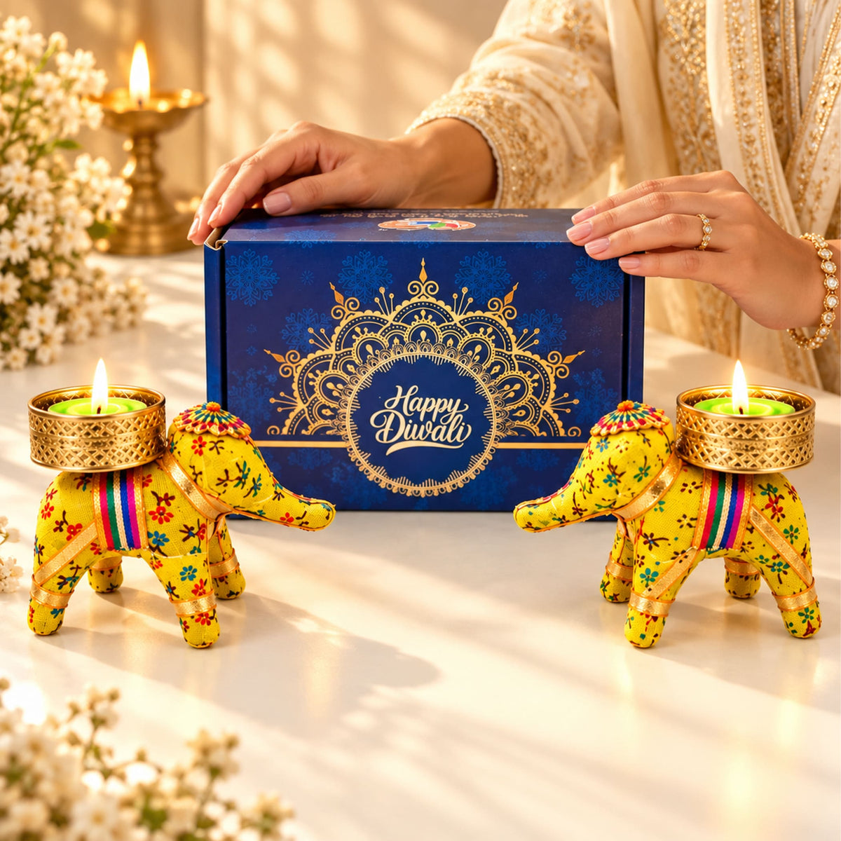 Vibrant yellow elephant-shaped candle holders with intricate floral embroidery rainbow ribbons and golden bases for diwali gifts