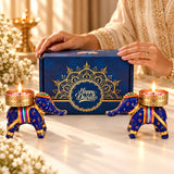 Blue and gold elephant-shaped candle holders with intricate patterns included in handmade diwali gift hamper for home office use