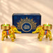 Two vibrant yellow elephant-shaped candle holders with colorful floral embroidery and gold-trimmed bases holding lit green candles for Diwali gifts