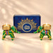 Green elephant-shaped candle holders with gold-trimmed bases and colorful stripes for diwali gift hampers