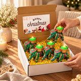 Gift box with four green elephant-shaped tealight candle holders featuring gold and red patterns for festive gifting