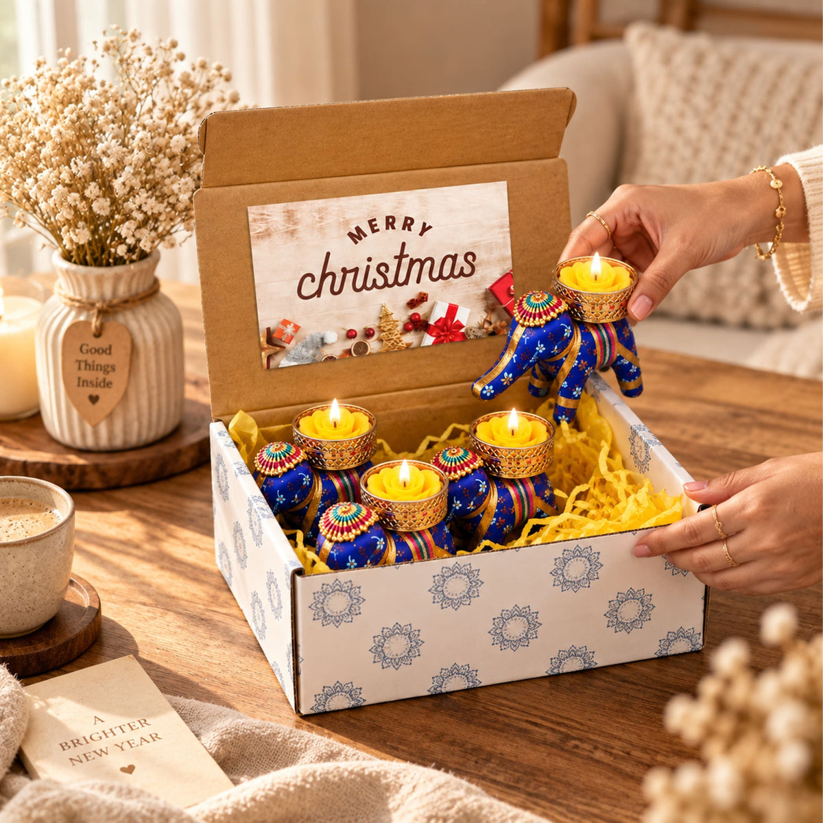 Gift box with 4 blue and gold elephant-shaped tealight candle holders with intricate patterns for Diwali and festive gifting