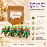 Set of four green elephant-shaped tea light holders with gold detailing and fabric accents for festive gifting