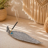 Silver leaf-shaped elephant incense stick and cone holder with intricate filigree and a blue gemstone accent for mess free use
