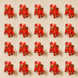 Red elephant-shaped tea light candle holders with gold and green embroidered details for festive home decor