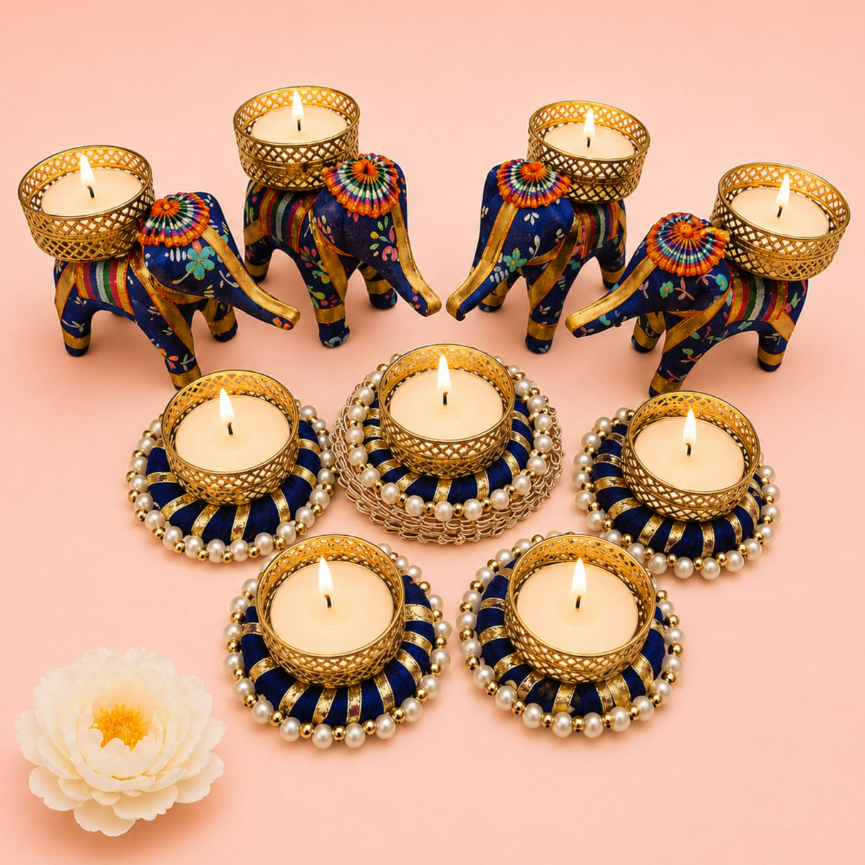 Blue and gold elephant-shaped tealight candle holders with intricate floral patterns and pearl accents for festive decor