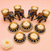 Blue and gold elephant-shaped tealight candle holders with intricate floral patterns and pearl accents for festive decor