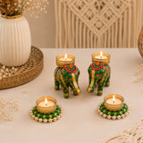 Green and gold elephant-shaped tealight candle holders with intricate floral patterns and beaded bases for festive decor