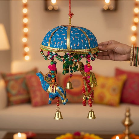 A vibrant blue and gold elephant umbrella door hanging with colorful beaded tassels and golden bells for traditional decor