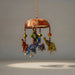 A vibrant handcrafted elephant umbrella door hanging with painted elephants and floral domed canopy for home decor