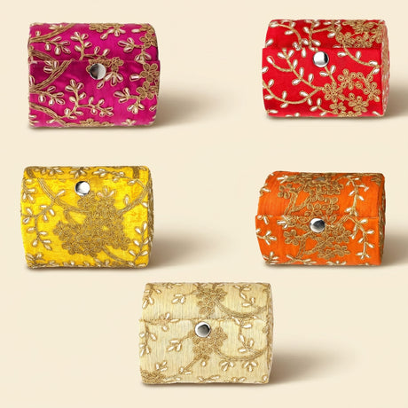 Vibrant embroidered bangle organizing boxes in pink red yellow orange and cream with gold floral patterns and silver closures