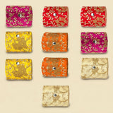Vibrant embroidered fabric pouches in pink red yellow and orange with gold floral patterns for bangle organizing box