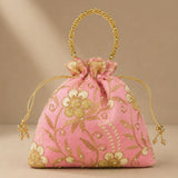 Designer potli bag in pink with embroidered floral detail pearls and gold bead handle for weddings and party favors