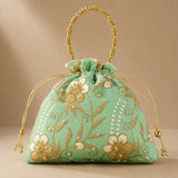 A mint green embroidered designer potli bag with gold and white floral patterns pearls and beaded handle for weddings