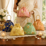 Designer potli bag pink embroidered drawstring pouch with gold floral patterns and beaded handles for weddings and gifts