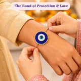 A beaded blue and white evil eye bracelet with a gold toned chain from the evil eye seed rakhi gift hamper for brother