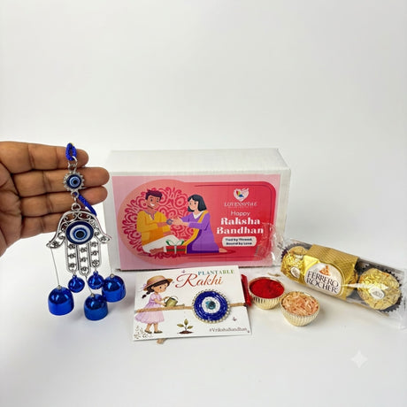 Blue and silver hamsa hand charm with dangling blue bells in evil eye seed rakhi gift hamper for brother