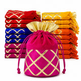 A vibrant fuchsia velvet traditional indian potli bag with gold lattice gota patti work and drawstring closure for festive use