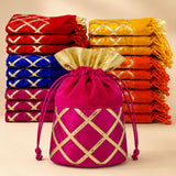 A vibrant fuchsia velvet potli bag with gold lattice embroidery and drawstring for festive and wedding return gifts