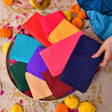 Unstitched floral multicolor blouse pieces in vibrant patterned fabric squares with metallic dot designs for indian gifts
